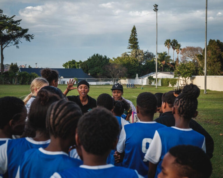 Girls discussing game plan on sideline